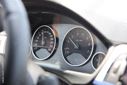 A close up of a car with the speedometer showing the speedometer.
