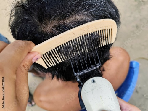 man having his hair cut photo