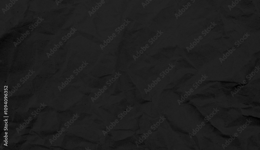 Recycled black creased paper background from a paper packing. Crumpled brown paper texture concept Recycled black creased paper background from a paper packing. Crumpled brown paper texture concept