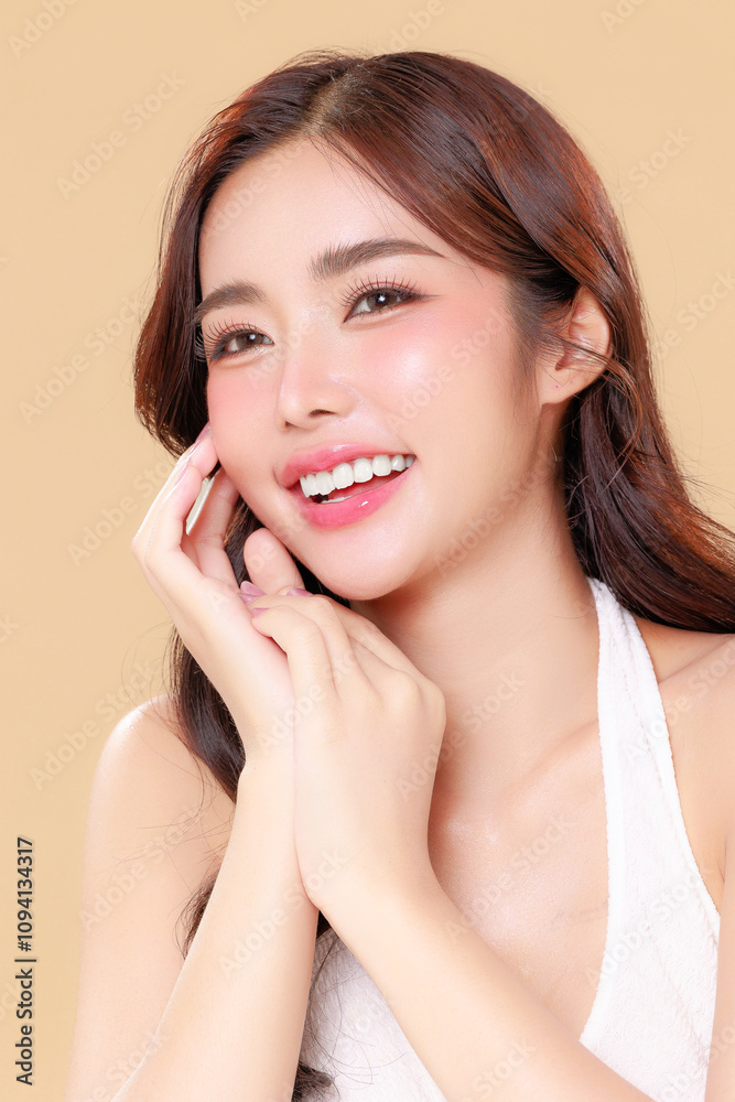Pretty Asian beauty woman curly long hair with Korean makeup glowing face and healthy facial skin portrait smile on isolated beige background. Cosmetology ,Plastic surgery. Pretty Asian beauty woman curly long hair with Korean makeup glowing face and healthy facial skin portrait smile on isolated beige background. Cosmetology ,Plastic surgery.