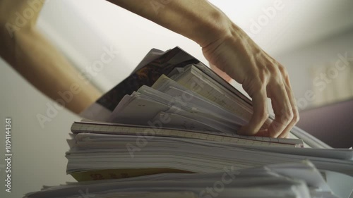 A man stacking a pile of paperwork