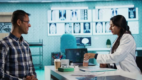 Wallpaper Mural Indian medic and patient discuss about skincare products at dermatology check up, woman offering sunscreen protection cream to young man. SPF moisturizer lotion recommendation. Camera B. Torontodigital.ca