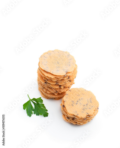 Stack of thin round crispbreads with herbs isolated on white photo