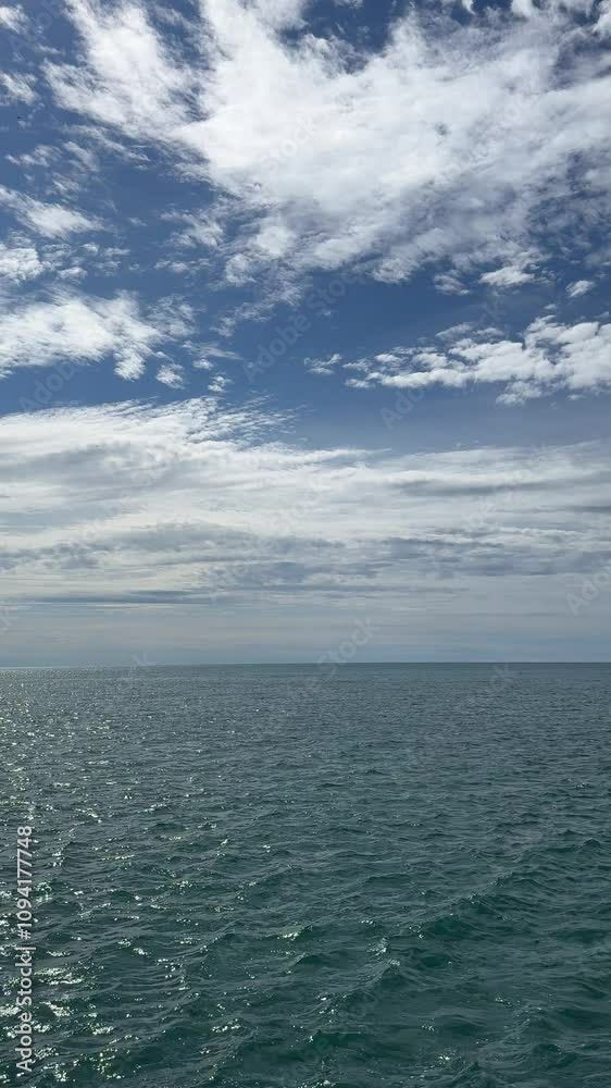 Beautiful clouds over sea waves, vertical video. Beautiful clouds over sea waves, vertical video.