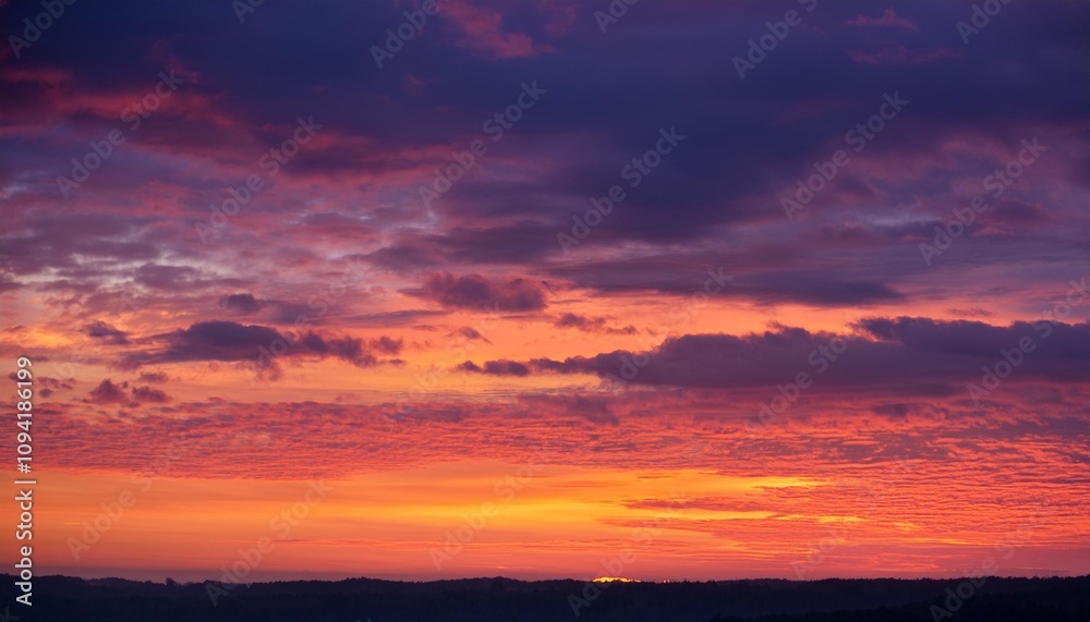 A mesmerizing sunset casts a warm glow on the landscape below A mesmerizing sunset casts a warm glow on the landscape below