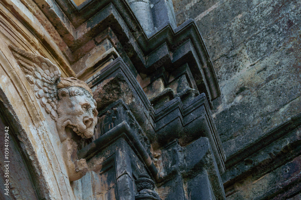 ronda,malaga,spain gargoyle on the facade of a stone church darkened by time ronda,malaga,spain gargoyle on the facade of a stone church darkened by time