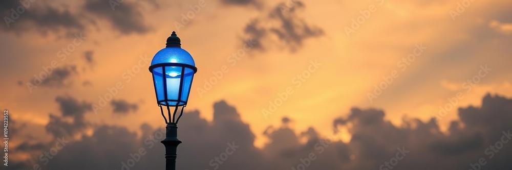 Street lamp with blue light cast on a cloudy sky at sunset, cityscape, blue Street lamp with blue light cast on a cloudy sky at sunset, cityscape, blue