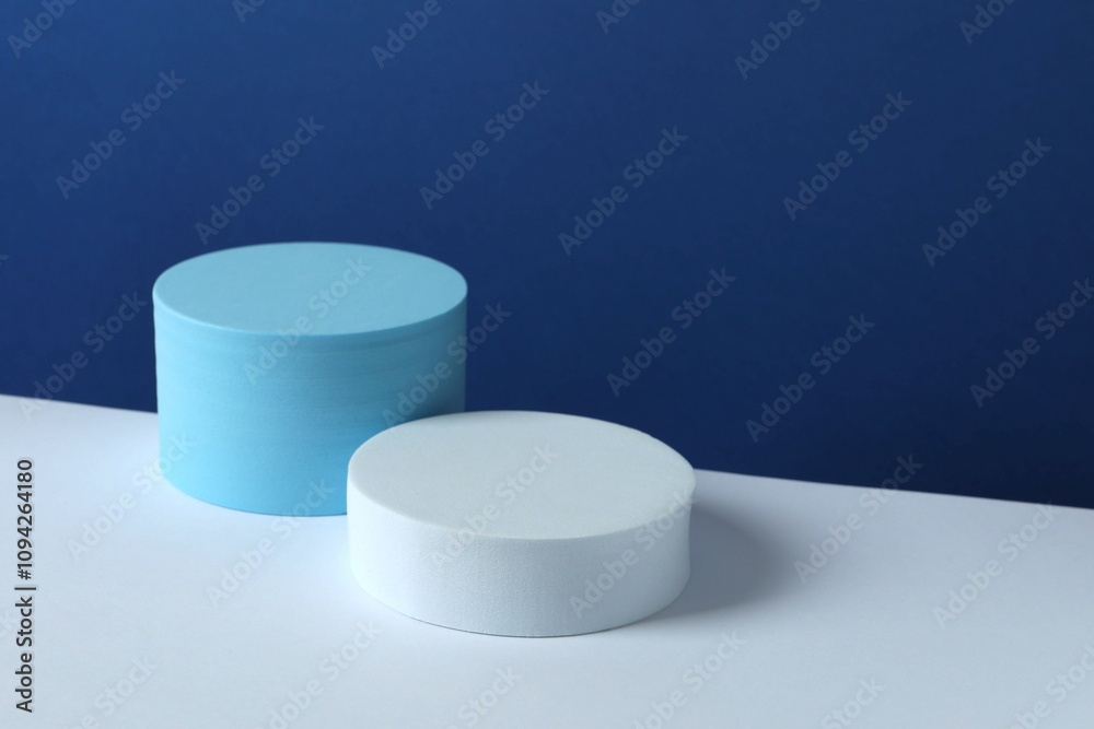 White podiums on color background 
