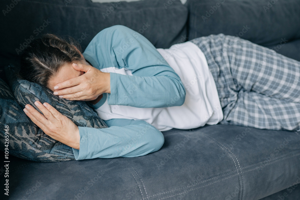 Sad depressed emotionally upset woman lying on the bed covers her face with her hands. Sad depressed emotionally upset woman lying on the bed covers her face with her hands.