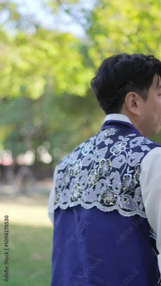 A Korean couple, a man in his 30s and a woman in her 20s, spends time together at a historical park in Seoul, South Korea. Vertical video A Korean couple, a man in his 30s and a woman in her 20s, spends time together at a historical park in Seoul, South Korea. Vertical video