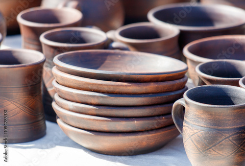 A collection of brown ceramic dishes and cups