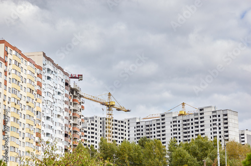 Tower crane building a house. Concrete building under construction. Construction site