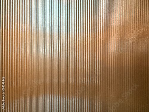 Texture of matt golden bronze fluted glass, or striped glass. Fluted glass is aesthetically beautiful in interior finishes and used for doors and partition. Seamless fluted glass panel.