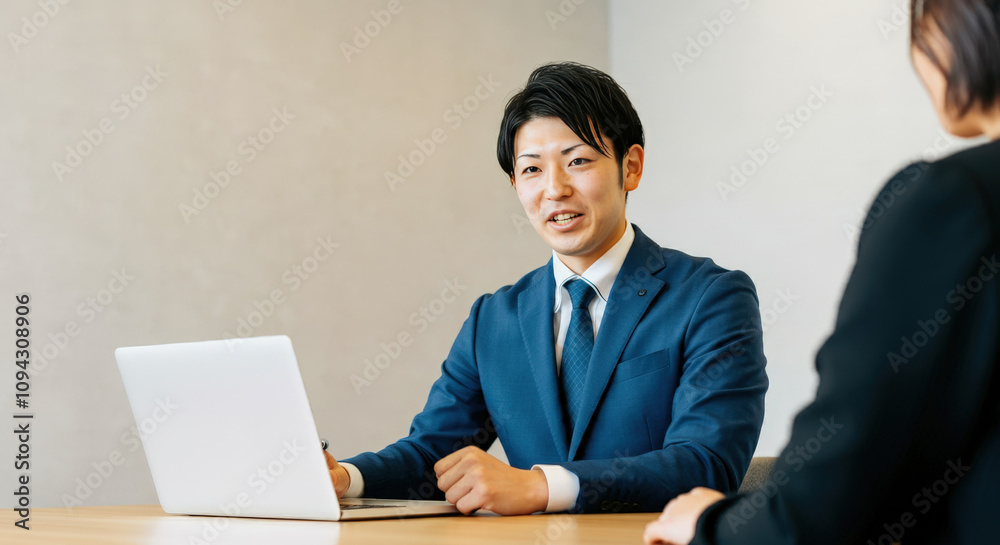 A young businessman negotiating with a client smiling A young businessman negotiating with a client smiling