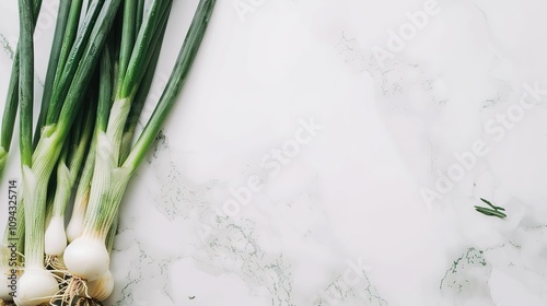Green Scallions on a White Background - a fresh and minimal visual. The vibrant green scallions pop against the clean white backdrop, creating a crisp and natural look.