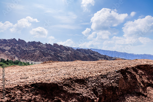 Gravel road platform and Danxia landform mountain natural background in Xinjiang. Outdoor road background.