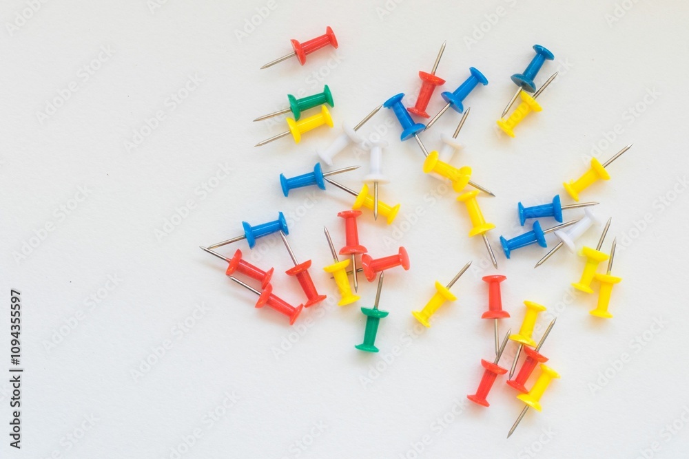 Pile of colorful push pins on a plain white background, ideal for office or school themes. Pile of colorful push pins on a plain white background, ideal for office or school themes.