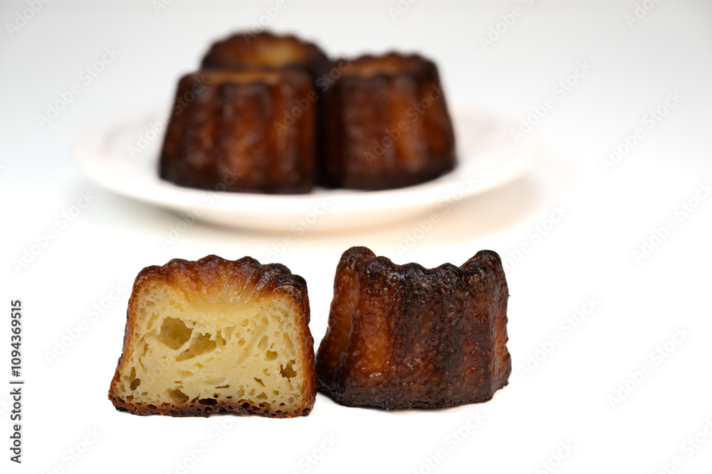 Caneles de bordeaux, traditional French sweet dessert with white table background, High quality photo Caneles de bordeaux, traditional French sweet dessert with white table background, High quality photo