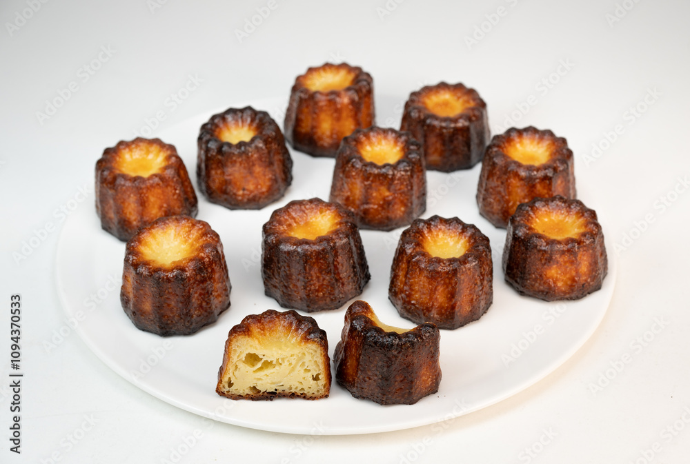 Caneles de bordeaux, traditional French sweet dessert with white table background, High quality photo Caneles de bordeaux, traditional French sweet dessert with white table background, High quality photo