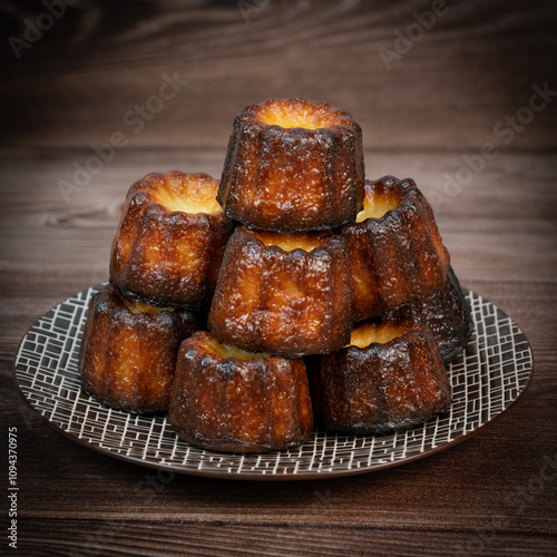 Caneles de bordeaux, traditional French sweet dessert with white table background, High quality photo photo