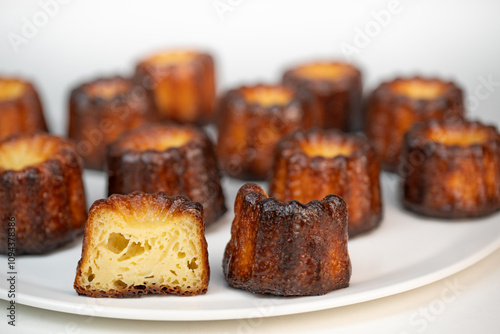 Caneles de bordeaux, traditional French sweet dessert with white table background, High quality photo photo