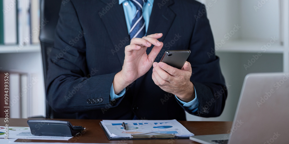 Business Professional Using Smartphone in Office Setting Business Professional Using Smartphone in Office Setting