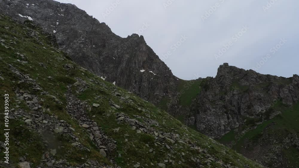Mountain peak of Mount Shymbulak in Almaty. Snow in places. Mountain picturesque landscape Mountain peak of Mount Shymbulak in Almaty. Snow in places. Mountain picturesque landscape