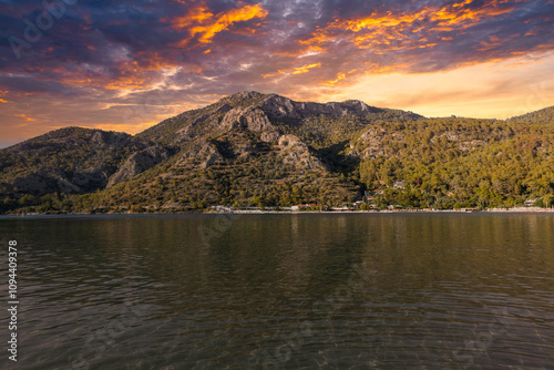 Fototapeta Naklejka Na Ścianę i Meble -  Mugla, Fethiye - Turkiye - 18 October 2024: View of The Beach Near Sunset