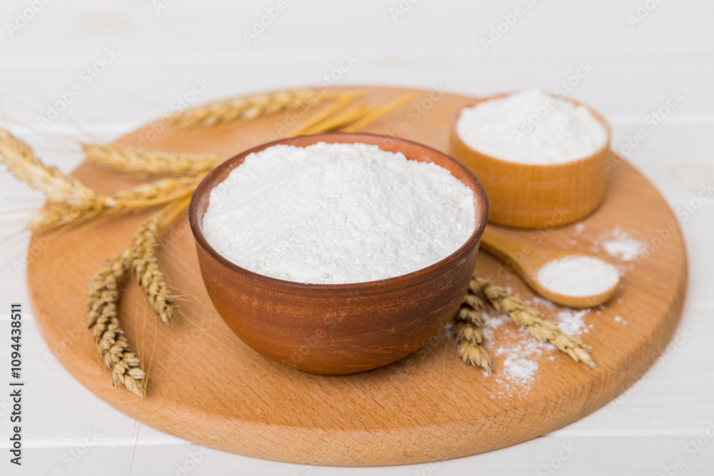Flat lay of Wheat flour in wooden bowl with wheat spikelets on colored background. world wheat crisis Flat lay of Wheat flour in wooden bowl with wheat spikelets on colored background. world wheat crisis