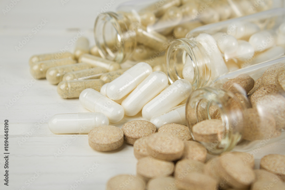 Vitamin capsules and dietary supplements on a light background. Vitamin capsules and dietary supplements on a light background.