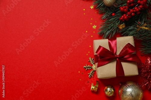 Beautiful gift box tied with bow Christmas decorations, confetti on color background 