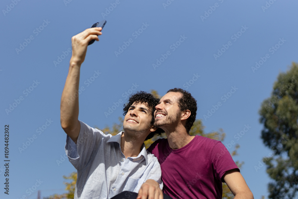 Gay couple taking a selfie outdoors on a sunny day. Copy space Gay couple taking a selfie outdoors on a sunny day. Copy space