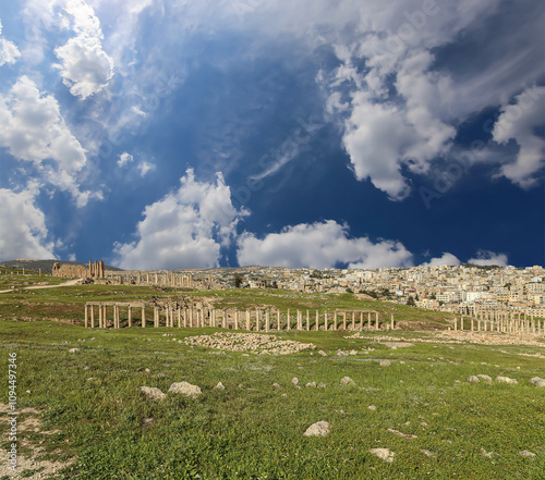 Roman ruins (against the background of a beautiful sky with clouds) in the Jordanian city of Jerash (Gerasa of Antiquity), capital and largest city of Jerash Governorate, Jordan #1094497346