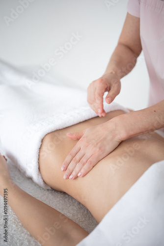 A woman receiving a belly massage at a beauty salon