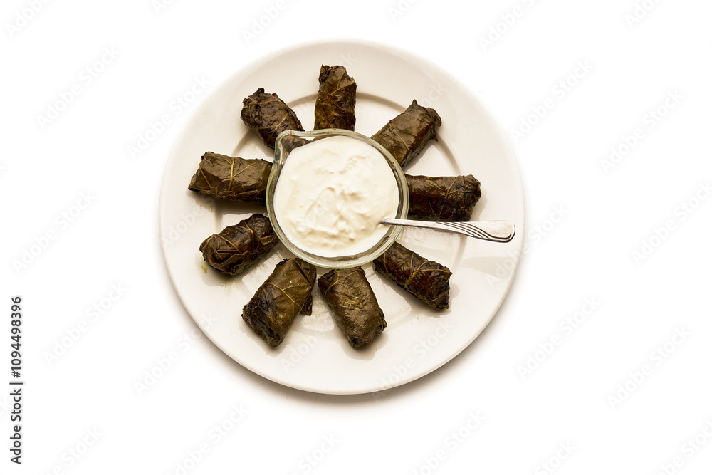 A plate of stuffed vegetables with a white sauce A plate of stuffed vegetables with a white sauce