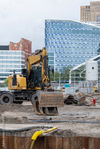 A powerful excavator operates at a bustling construction site, capturing the essence of urban development and the transition of landscapes in modern cities in Amsterdam Zuid