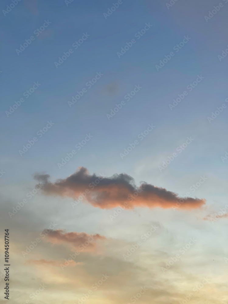 Fototapeta premium Beautiful colorful sky and cloud in twilight time background. Orange fluffy clouds and sun sunlight reflection in the blue sky.