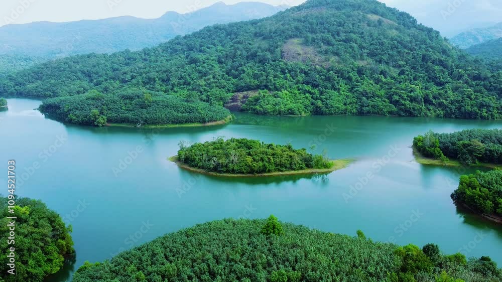 The green mountains and blue waters are soothing to the eyes. Areal view of a Beautiful dam in Kerala. Neyyar The green mountains and blue waters are soothing to the eyes. Areal view of a Beautiful dam in Kerala. Neyyar