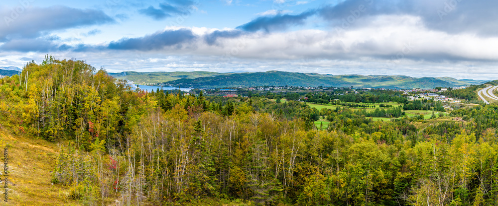 A view over treetops towards Corner Brook in Newfoundland, Canada in the fall A view over treetops towards Corner Brook in Newfoundland, Canada in the fall