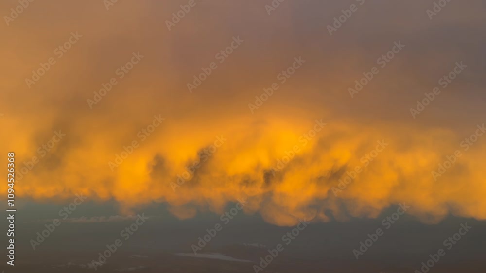 POV flying under a golden color cloud illuminated by the dawn light as seen by the pilots of a jet airplane. Immersive pilot’s perspective. 4K 60FPS POV flying under a golden color cloud illuminated by the dawn light as seen by the pilots of a jet airplane. Immersive pilot’s perspective. 4K 60FPS