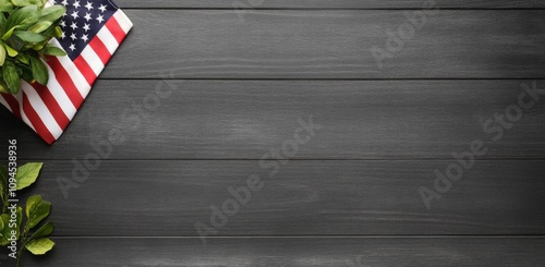 American flag resting on dark wooden surface with greenery