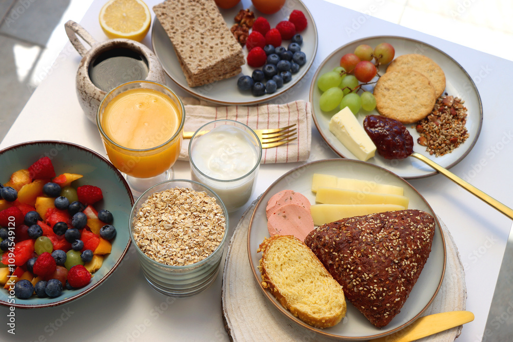 Assortment of various breakfast foods and drinks on the white table. Selective focus. Assortment of various breakfast foods and drinks on the white table. Selective focus.