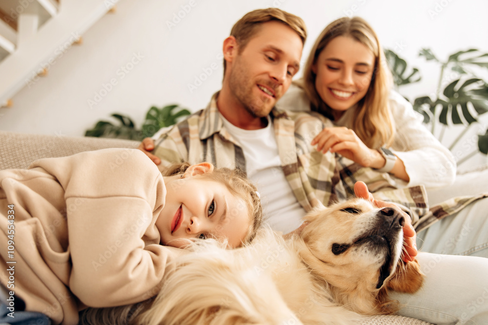 Smiling beautiful family young mother father and little daughter relaxing together woman hugging man Smiling beautiful family young mother father and little daughter relaxing together woman hugging man