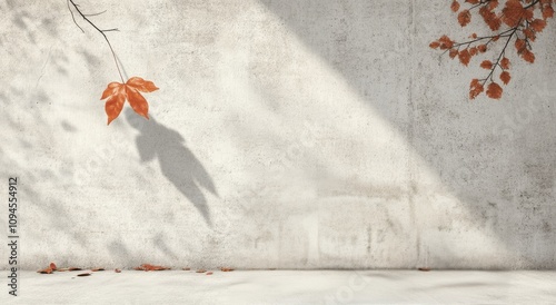 Autumn leaves casting shadows on a textured wall in soft sunlight