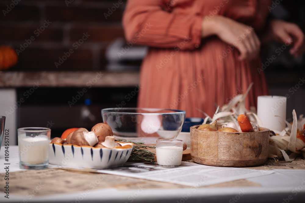 kitchen, a woman cooks, food and plates on the table kitchen, a woman cooks, food and plates on the table