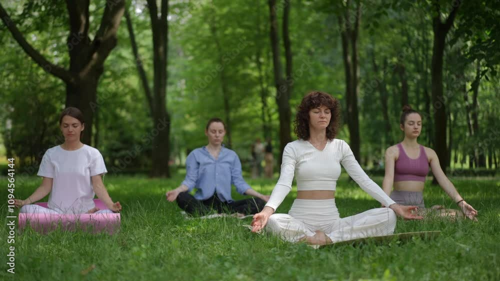 A serene yoga meditation session guided by a teacher dressed in white, surrounded by a peaceful forest. Participants sit cross-legged on mats, practicing mindful breathing and meditation, embracing A serene yoga meditation session guided by a teacher dressed in white, surrounded by a peaceful forest. Participants sit cross-legged on mats, practicing mindful breathing and meditation, embracing
