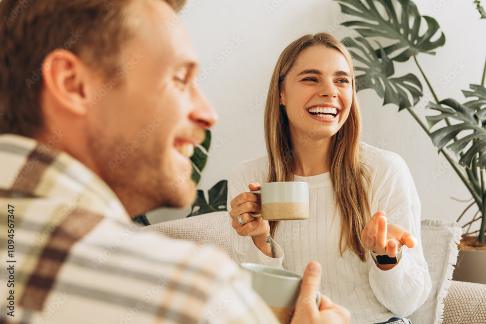 Happy attractive smiling couple woman and man drinking together coffee, having coffee break, talking Happy attractive smiling couple woman and man drinking together coffee, having coffee break, talking