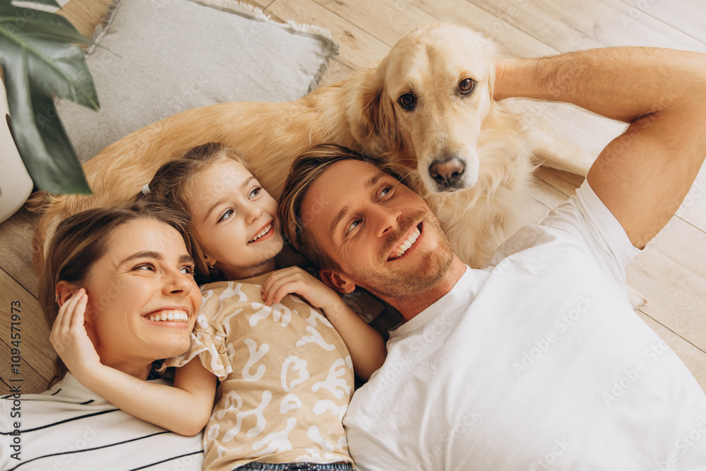 Portrait of happy family, beautiful mother, father, cute little daughter playing together with dog