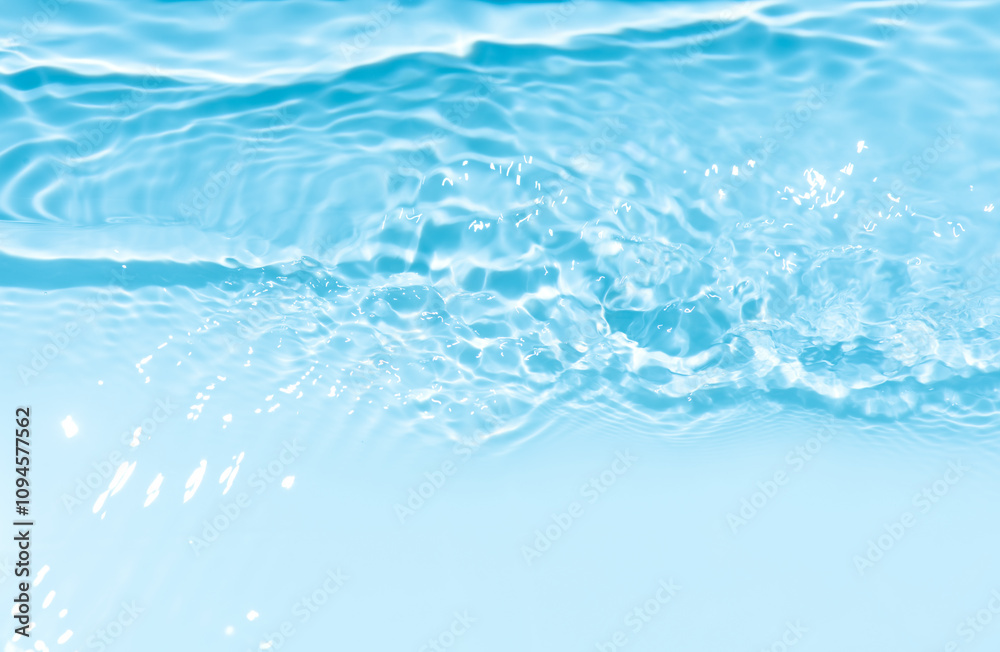 Blue water with ripples on the surface. Defocus blurred transparent blue colored clear calm water surface texture with splashes and bubbles. Water waves with shining pattern texture background. Blue water with ripples on the surface. Defocus blurred transparent blue colored clear calm water surface texture with splashes and bubbles. Water waves with shining pattern texture background.