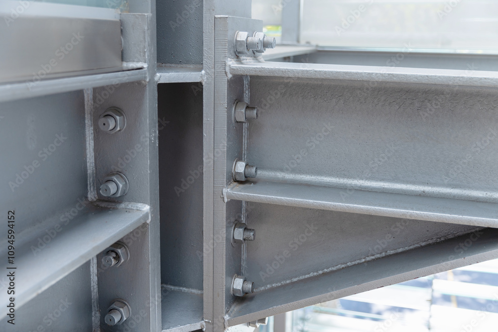 Gray metal girders connected with bolts, close-up photo Gray metal girders connected with bolts, close-up photo